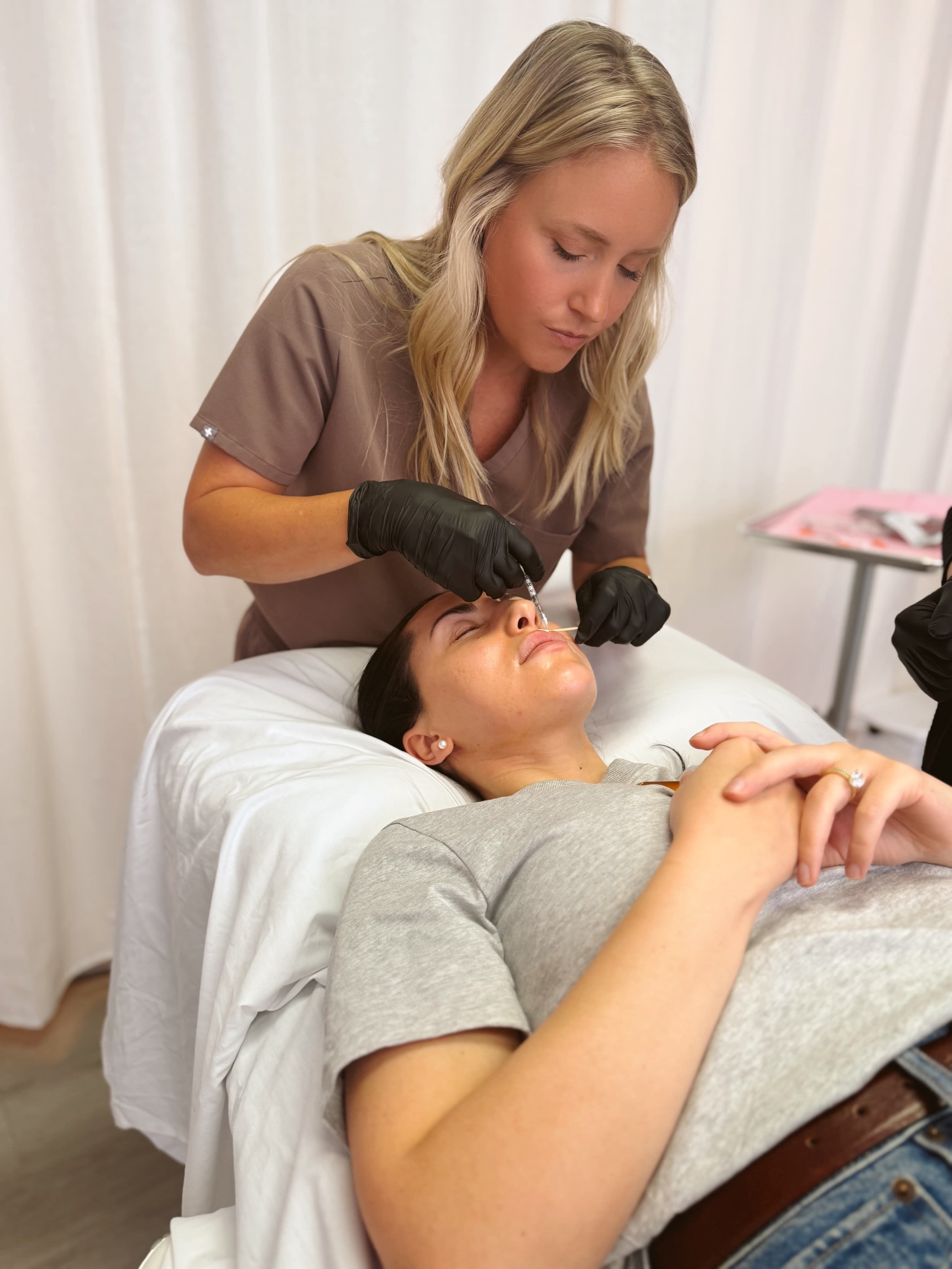Nurse Jayme performing a precise filler injection on a client at Next Ov Skin
