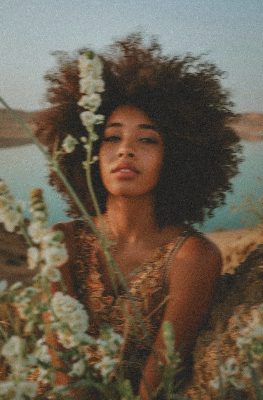 Woman with radiant skin among flowers
